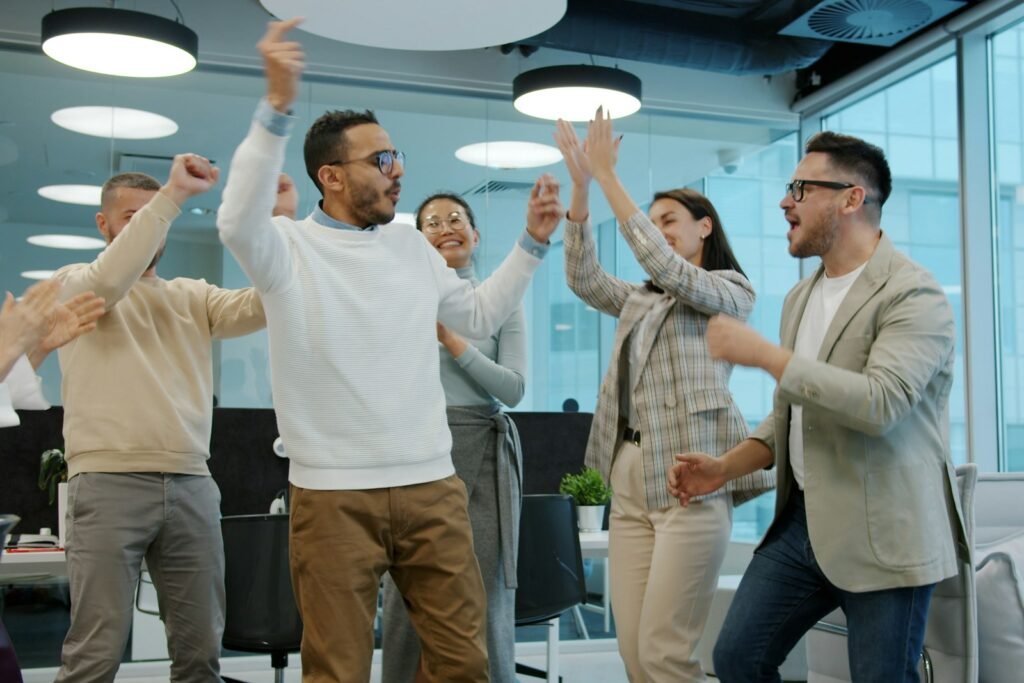 Marketing team celebrating a win in the office, showing marketing momentum