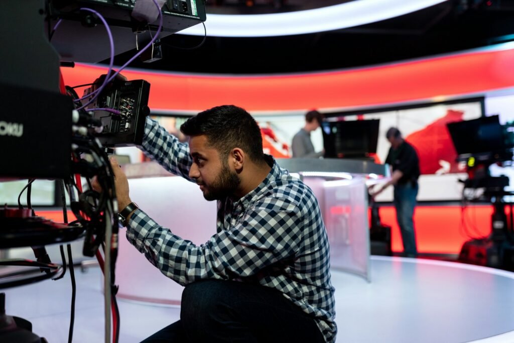 Technician operating equipment in a media production studio