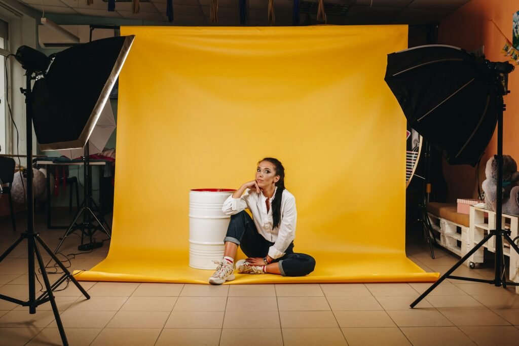 Photography studio in Singapore with softbox lights and a yellow backdrop during a photo shoot