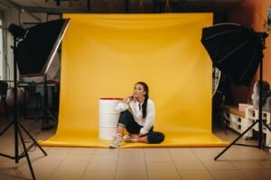 Photography studio in Singapore with softbox lights and a yellow backdrop during a photo shoot