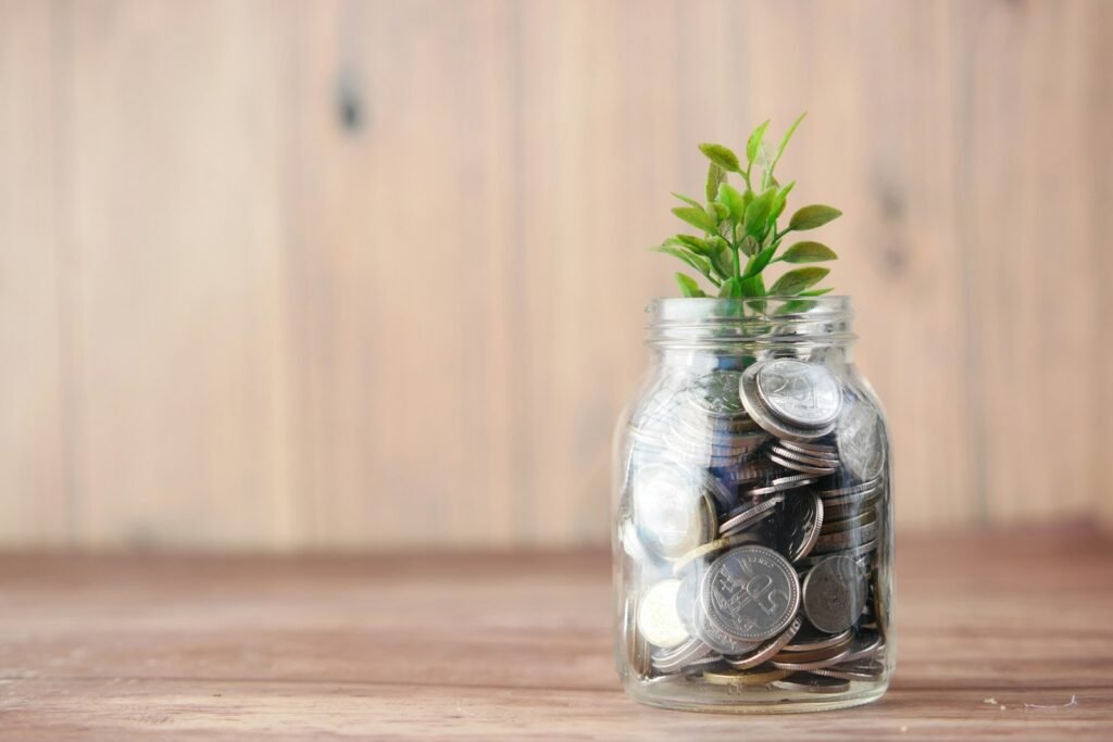 Plant growing from a jar of coins, representing PPC budget and return on investment