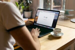 Person running a Google search on a laptop, representing SEM paid advertising