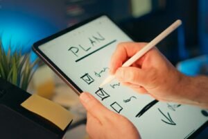 Checklist being written on a tablet, representing choosing an SEO company