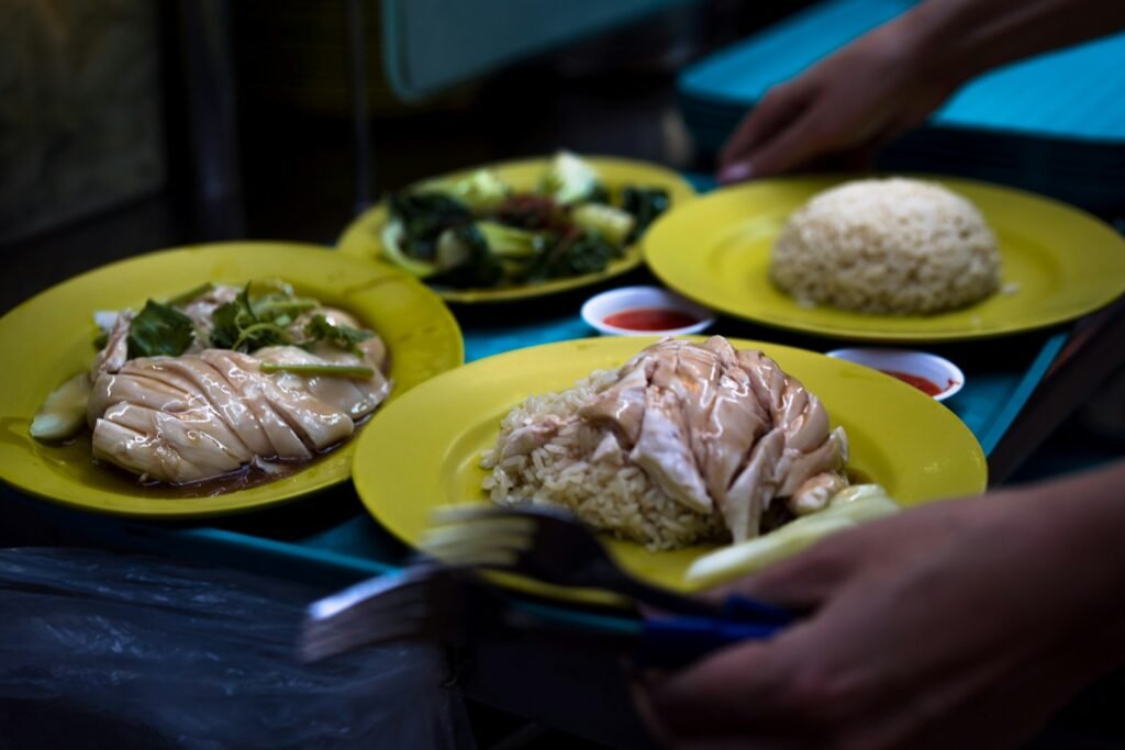 Plates of Singapore chicken rice being served, representing SEO for F&B brands