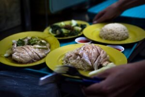 Plates of Singapore chicken rice being served, representing SEO for F&B brands