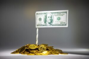 Banknote on a pile of coins, representing SEO pricing expectations