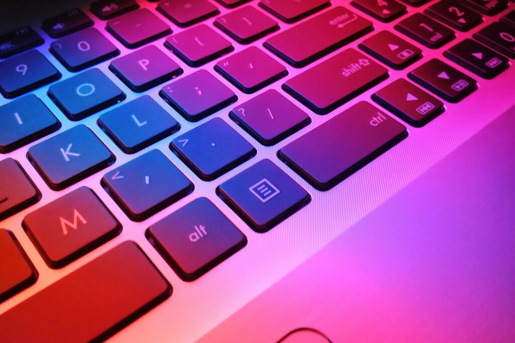 Laptop keyboard lit in colour, representing SEO and SEM search marketing