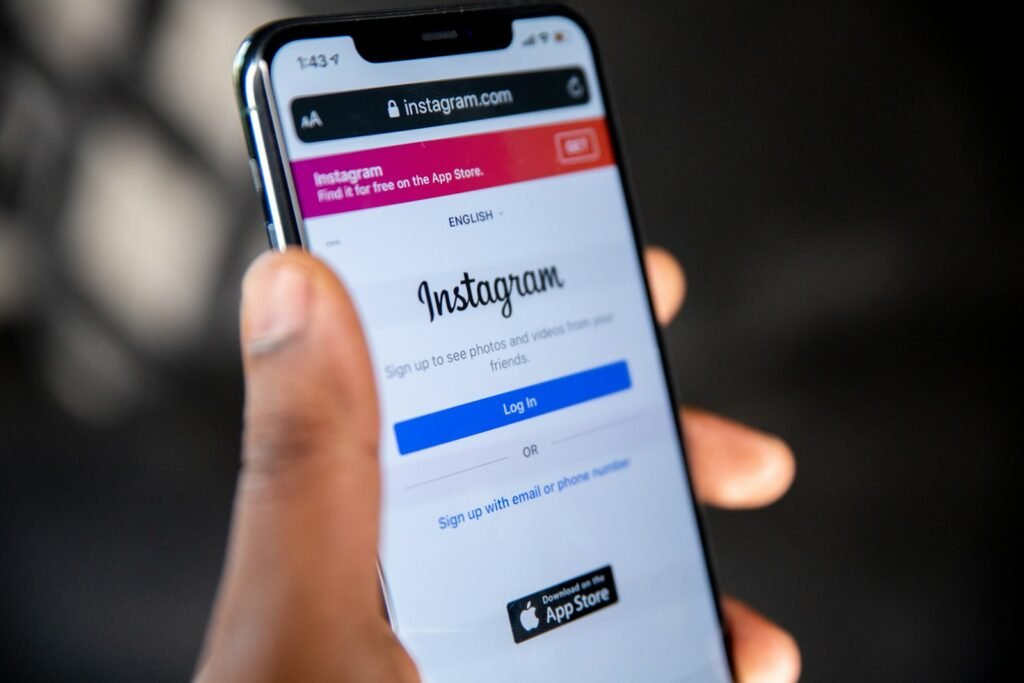 Hand holding a phone showing Instagram, representing social media agency services