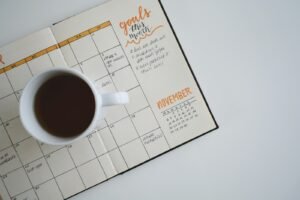 Content calendar with goals and a cup of coffee, representing social media management