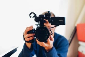 Videographer filming with a professional camera for a video marketing campaign