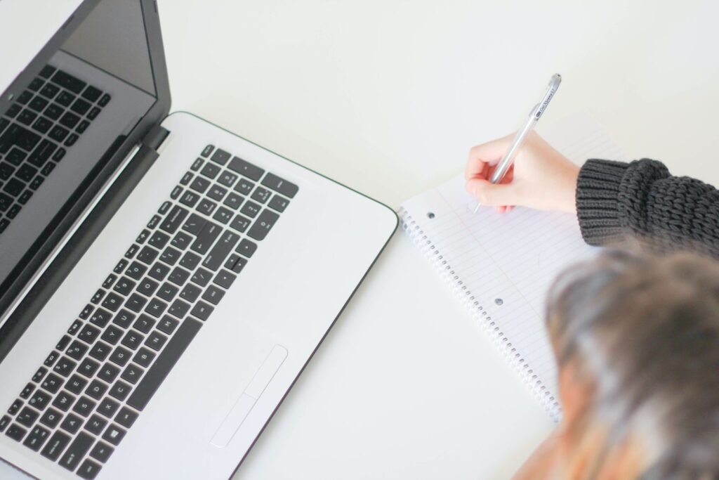 A founder marks up a printed homepage layout while weighing whether to use web copywriting services or write the pages in house.