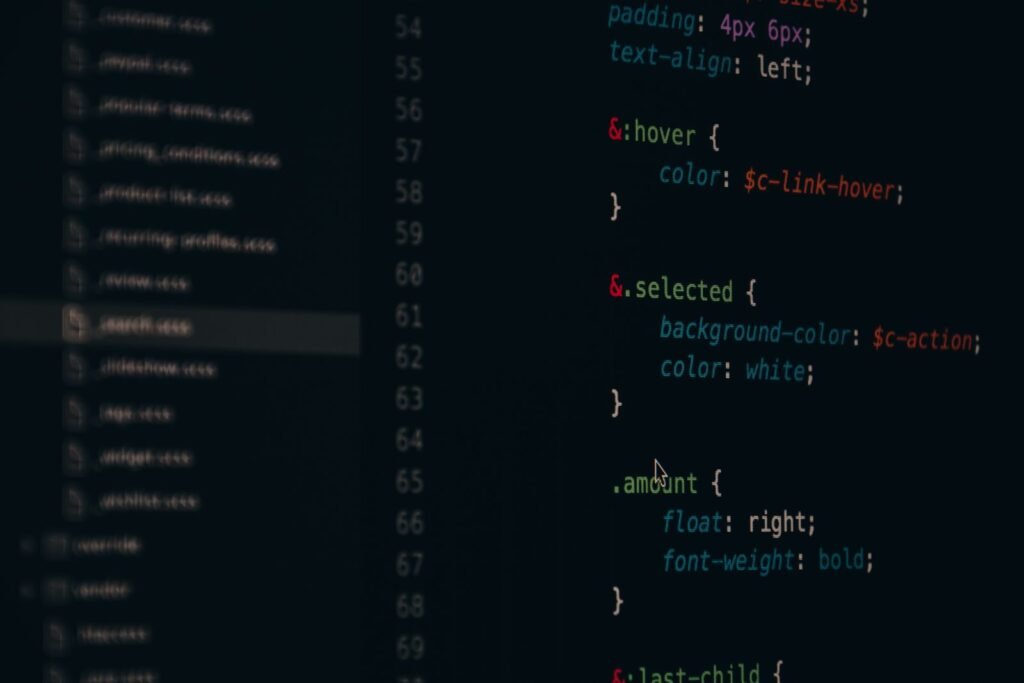 A developer writing code on screen while delivering web development services in Singapore.