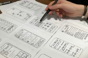 Designer sketching website wireframes for a website revamp