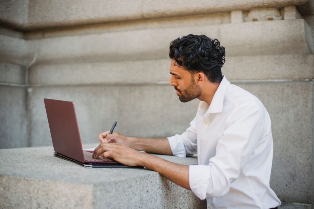 A developer at a WordPress website development agency reviewing an installed plugin list and code editor across two monitors.