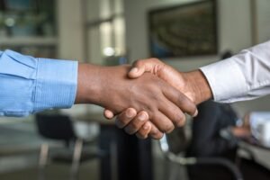 Handshake between business partners, representing working with an SEM agency