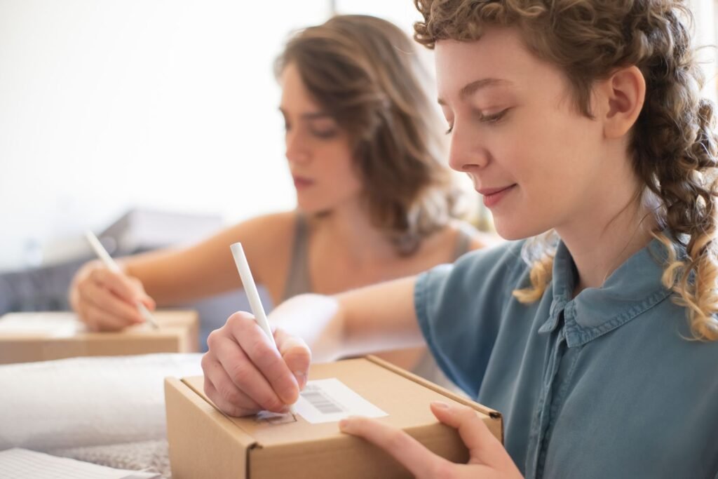 Singapore ecommerce seller reviews order costs beside packed parcels and a margin spreadsheet.
