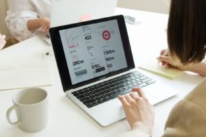 Singapore SME marketing manager reviewing website traffic and enquiry performance on a laptop.